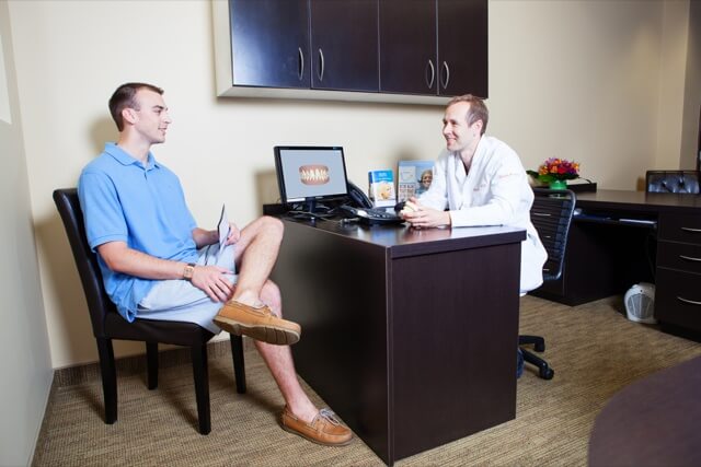 Our doctor consulting with a patient in an office with a computer