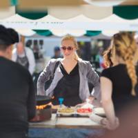 A woman at a booth choosing food